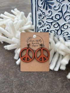 Embrace the spirit of peace and style with these beautifully handcrafted earrings from BeYou-tifully Made Designs. Each pair is made from solid walnut wood, skillfully laser-cut into a peace sign shape, hand-painted, and distressed for a rustic, vintage appeal. These lightweight statement earrings are the perfect boho accessory, adding a touch of hippie-chic to any outfit. Whether you're heading to a festival or simply expressing your love for peace, these earrings are a must-have. The hypoaller Boho Accessories, Jewelry Statement, Hippie Jewelry, Hypoallergenic Earrings, Wooden Earrings, Handcrafted Earrings, Boho Festival, Solid Walnut, Earring Findings