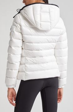 Whether you're headed somewhere metropolitan or mountainous, you'll stay warm in this sporty down puffer made from Moncler's water-resistant lacquered nylon. Elasticized cuffs and a detachable drawcord hood provide extra protection from the elements. Two-way front-zip closure Stand collar; removable drawcord hood Elastic cuffs with adjustable snap tab Front zip pockets; sleeve snap-flap pocket Lined, with down fill 100% polyamide Dry clean or machine wash, line dry Imported Designer Clothing White Sporty Quilted Outerwear, Sporty White Quilted Outerwear, White Nylon Puffer Jacket With Detachable Hood, Functional White Puffer Jacket With Detachable Hood, White Down Puffer Jacket For Cold Weather, White Sporty Puffer Jacket With Padded Collar, Casual White Duck Down Puffer Jacket, Sporty Quilted Down Puffer Jacket, White Duck Down Puffer Jacket With Padded Collar