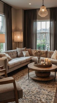 a living room with two couches and a coffee table in front of large windows