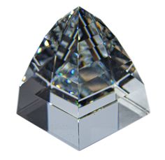 a crystal pyramid shaped object on a white background