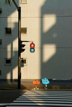 a person holding an umbrella standing in front of a traffic light on a city street