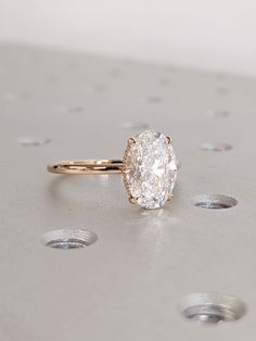 a diamond ring sitting on top of a table