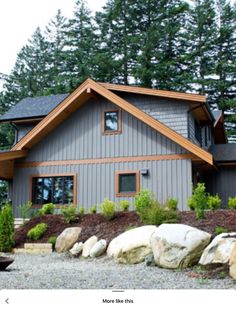 a house that is surrounded by rocks and trees