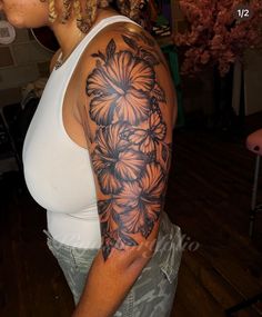 a woman with a flower tattoo on her arm