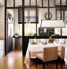 the dining room table is set with white linens