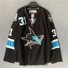 a hockey jersey with the number 13 on it and an image of a sharks logo