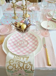 an easter table setting with pink and white napkins