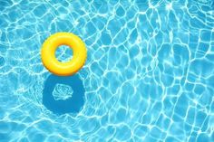 an inflatable ring floating on top of a swimming pool with water ripples