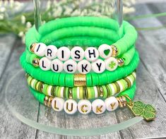 green bracelets with lucky charms are stacked on top of each other and the words irish lucky written in gold