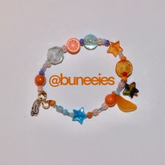 🍊🥭🍑🌀 juicy blue and orange clementine handmade beaded bracelet 🍊✨ brighten up your day with a splash of citrus fun! 🧡💙🩵 handcrafted with love, this pastel orange & blue bracelet is perfect for adding a fruity touch to any outfit. 🧶⭐️ product details 🛍️ orange / clementine / tangerine fruit rubber bead charm translucent orange leaf charm ‘buneeies’ logo tag charm clear blue glowy orbs opaque shiny navy blue & sky blue star bead glass pastel seed beads gold accenting and wire. s-clip hook &... Tangerine Fruit, Fruit Bracelet, Navy Blue Sky, Rubber Bead, Orange Bracelet, Pastel Orange, Orange Leaf, Logo Tag, Bracelets Handmade Beaded