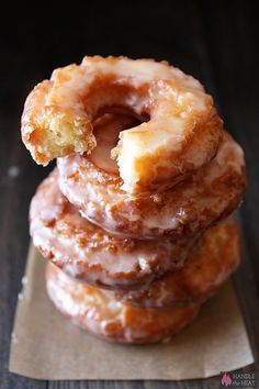 three glazed donuts stacked on top of each other with the words old fashioned sour cream doughnuts