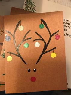 two christmas cards with reindeer's head and ornaments on them, one is made out of brown paper