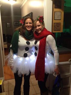 two women dressed up as snowmen standing next to each other