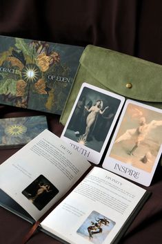 an open book with pictures on it next to some cards and a purse in front of them