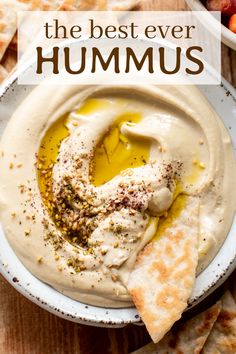 hummus in a bowl with pita chips on the side and text overlay that reads, the best ever hummus