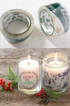 two candles are sitting next to each other on a wooden table with red berries and pine cones