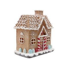 a gingerbread house is decorated with icing and candy