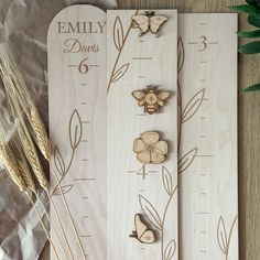 three wooden pins with flowers and butterflies on them