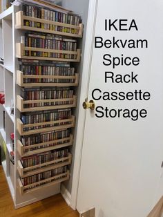 a book shelf filled with lots of books next to a white door in a room