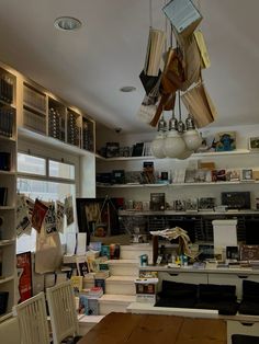 an open kitchen and dining room area with lots of books on the shelves above it