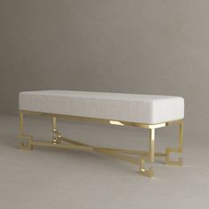 a white and gold bench on a gray background