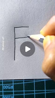 someone is drawing the letter f on paper