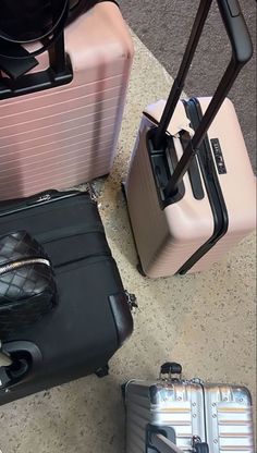 three pieces of luggage sitting on the ground next to each other with their handles extended