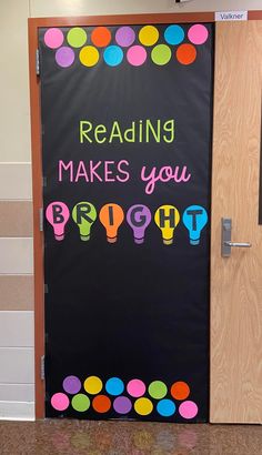 a classroom door decorated with the words reading makes you bright and happy on blackboard