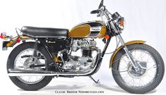 an old fashioned motorcycle is parked in front of a white background