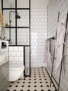 A modern industrial aesthetic paired with a Victorian tile bathroom floor and black fixtures