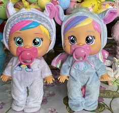 two dolls are standing next to each other