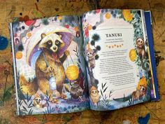 an open children's book with pictures of animals