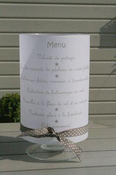 a table with a wine glass and menu on it