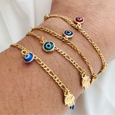 These Gold-Filled Evil Eye Bracelets Are Suitable For Protection And Negative Energies, They Bring The Hamsa Hand, An Ancient Amulet From The Middle East That Symbolizes The Hand Of God. They Come In Various Shades Of Blue And Red. Always Wear Your Bracelet And Protect Yourself From All Harm. Measurement: - Length: 7.5in - Evil Eye Width: 6.5mm - Hamsa Hand Width: 7mm - Figaro Link Width: 2.5mm Ancient Amulet, The Hand Of God, Eye Bracelets, Hand Of God, Bracelets Diy, Beaded Bracelets Diy, Jewelry Lookbook, Eye Bracelet, Evil Eye Bracelet