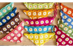 crocheted bikinis with flowers on them are laid out on a wooden surface