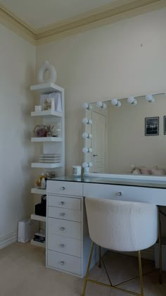 a white desk with a mirror and chair