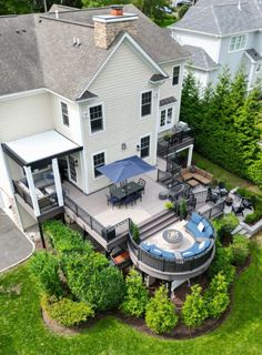 an aerial view of a large house with a patio and hot tub in the yard