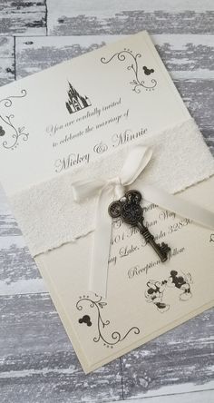 a wedding card with a key attached to it