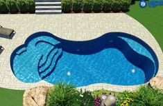 an aerial view of a swimming pool in the middle of a yard with lounge chairs around it