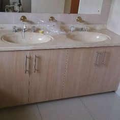 a bathroom with two sinks and a mirror