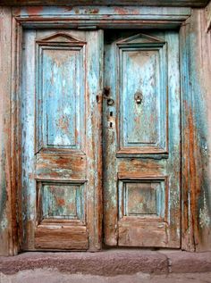 an old door is painted blue and brown