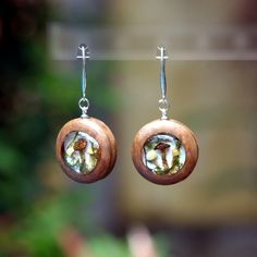 "Mushroom Crystal Earrings. Wood Resin Earrings. Wooden Earrings for Woman. Real Mushroom Jewelry.  ♥ This item is handmade, so each piece is unique. The piece you receive will be based on this design and very similar to photos. ♥♥ Please see the current discounts in the shop announcement: https://www.etsy.com/shop/TSMDecorations  Made very carefully by hand from carefully selected dried mushrooms, moss and wood. Real dried mushrooms and real moss are sealed in ultra-transparent resin. The edgin Nature-inspired Round Pressed Flowers Earrings, Nature-inspired Resin Earrings For Gifts, Nature-inspired Nickel Free Round Earrings, Nickel-free Round Nature-inspired Earrings, Nickel-free Round Resin Earrings, Magic Mushroom Art, Wood Resin Earrings, Epoxy Earrings, Mushroom Crystal