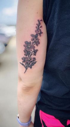 a woman with a flower tattoo on her arm