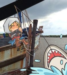 an image of a cartoon character on the side of a boat in the water with a shark painted on it