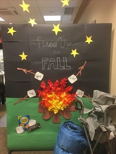 a bulletin board with some writing on it that says, send up for fall and there is a fire in the middle