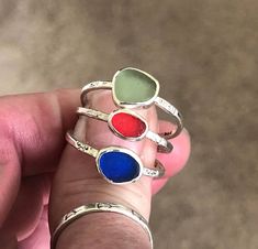 "These handcrafted Sterling Silver Stack Rings are sold individually. Color options are Sea Foam, Red or Cobalt. They have been handmade using 925 Sterling Silver that has been stamped and lightly oxidized. The glass is approximately 1/4\" wide and the bands are 1/16\" wide and cannot be resized. Size 10 Add a pop of vibrant color to your jewelry collection with these stunning Sea Glass Sterling Silver Stack Rings. Handcrafted with love and attention to detail, these unique pieces feature a capt Unique Handmade Green Stackable Rings, Unique Adjustable Oval Stackable Rings, Unique Handmade Adjustable Stackable Rings, Unique Handmade Stackable Rings As Gift, Unique Handmade Stackable Rings For Gift, Silver Stone Rings, Stack Rings, Beachglass Jewelry, Sterling Silver Stacking Rings