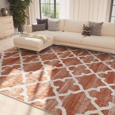 a living room with a large rug on the floor and a couch in front of it