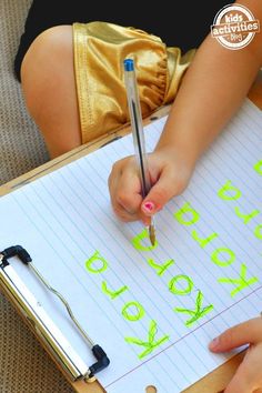 a child is writing on a piece of paper