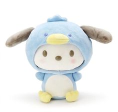 a small stuffed animal with ears and nose sitting on a white surface, wearing a blue outfit