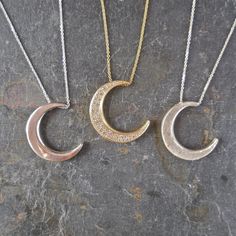 "This unique crescent moon phase pendant is available in silver or 14 k gold. So beautiful polished but equally stunning hand-finished matte, hammered or have it encrusted with diamonds. A focal piece that can be stacked with smaller pendants. It's a slide providing space for a pendant to fit into the opening. We've paired it with our bezel set moonstone. crescent moon 24 millimeters long x 19 mm wide or/ almost 1\" long x 3/4\" wide 14k solid gold or sterling silver pave Diamond encrusted Cresc Gold Hammered Half Moon Jewelry, Hammered Gold Half Moon Jewelry, Hand Forged Moon-shaped Gold Jewelry, Luxury Silver Jewelry With Moon Charm, Hand Forged Moon Shaped Gold Jewelry, Elegant Crescent Hammered Jewelry, Anniversary Jewelry With Half Moon Charm, Elegant Hammered Crescent Jewelry, Elegant Crescent Shaped Hammered Jewelry